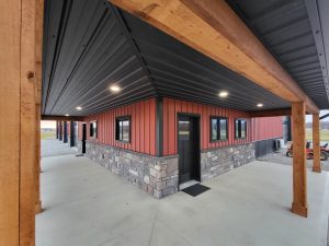 Red Board and Batten siding with a black Ram Panel ceiling